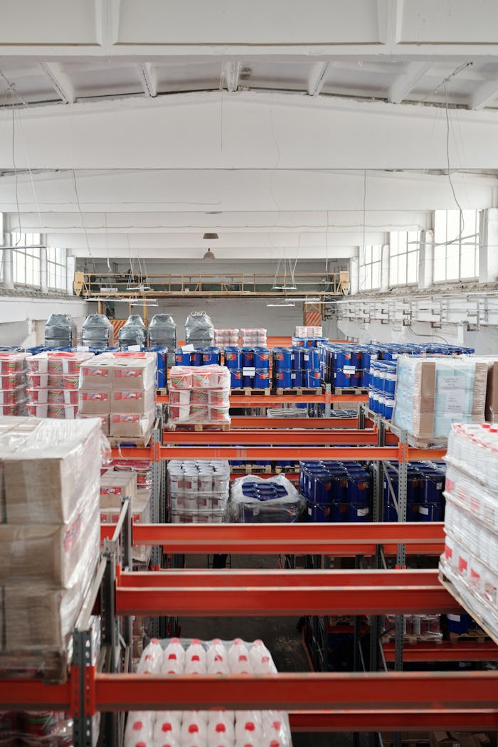 portfolio-01 Interior of a large warehouse with neatly organized goods on shelves, ready for shipment.