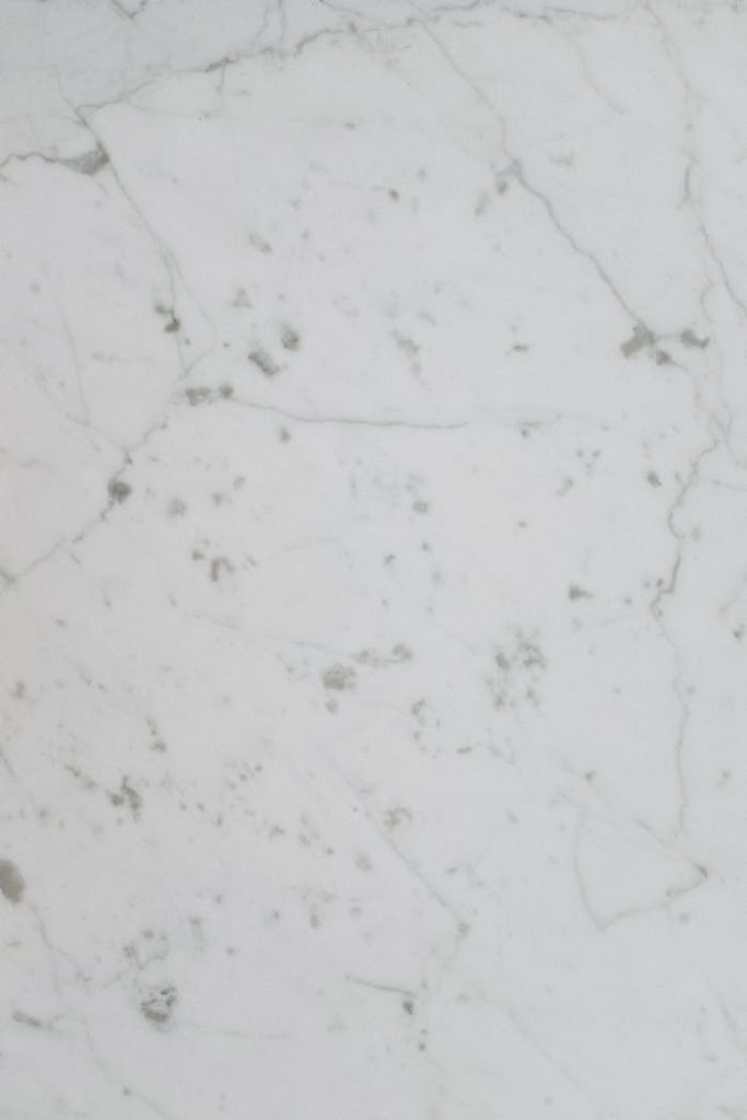 Elegant white marble with subtle gray veins, perfect for backgrounds or product displays.
